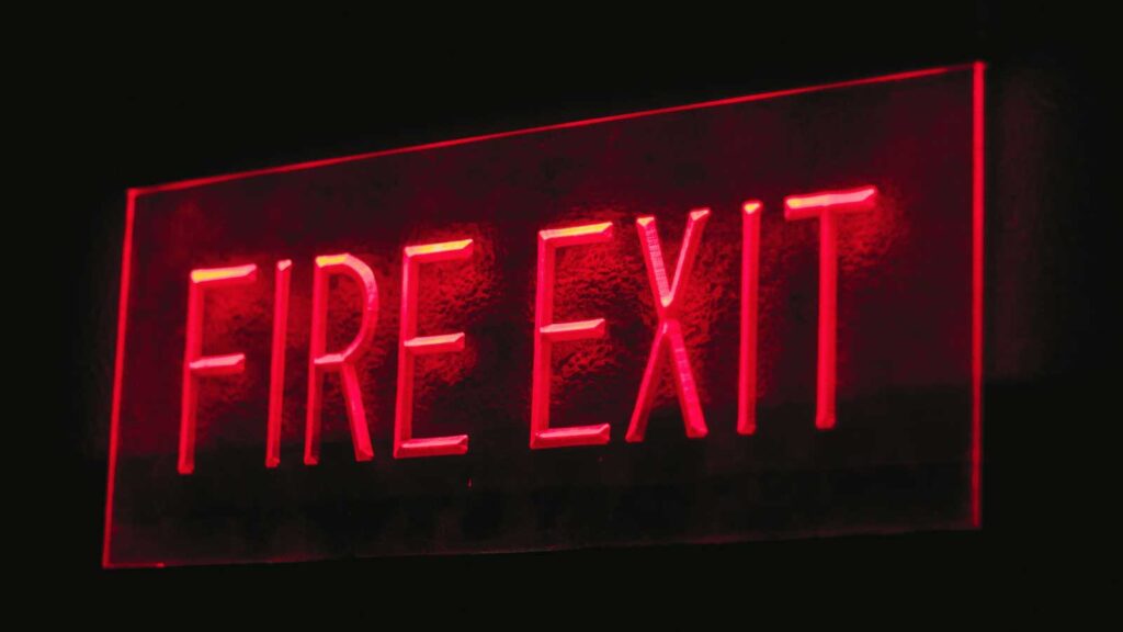 Fire Safety Risks for Commercial Buildings – Emergency fire exit sign for quick building evacuation.