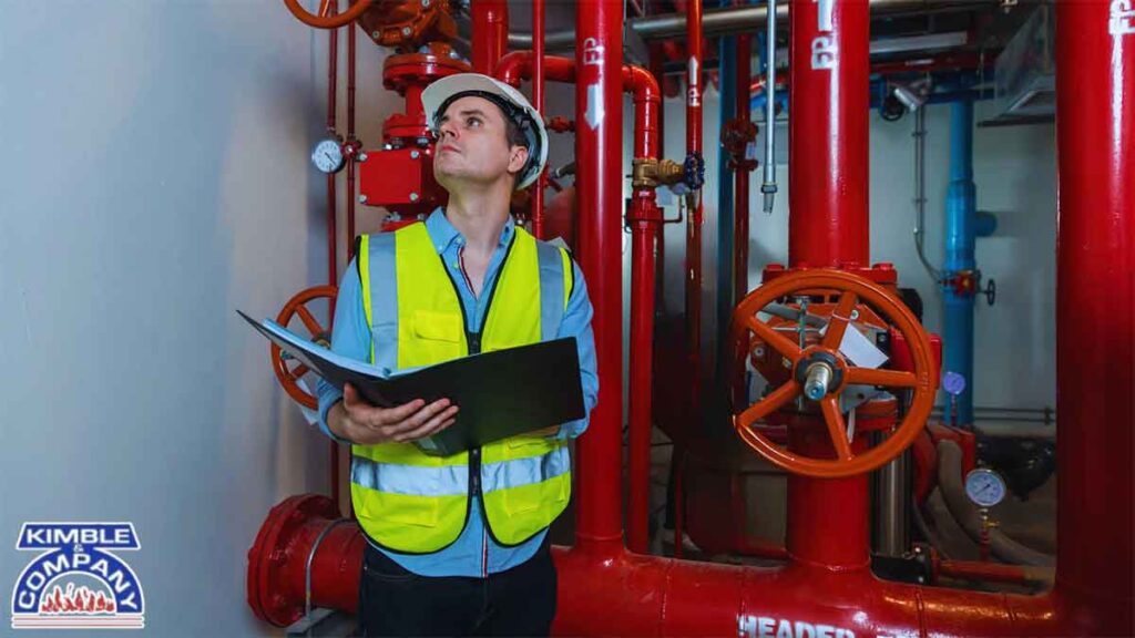 Fire safety technician reviewing fire sprinkler system during annual fire inspections made simple