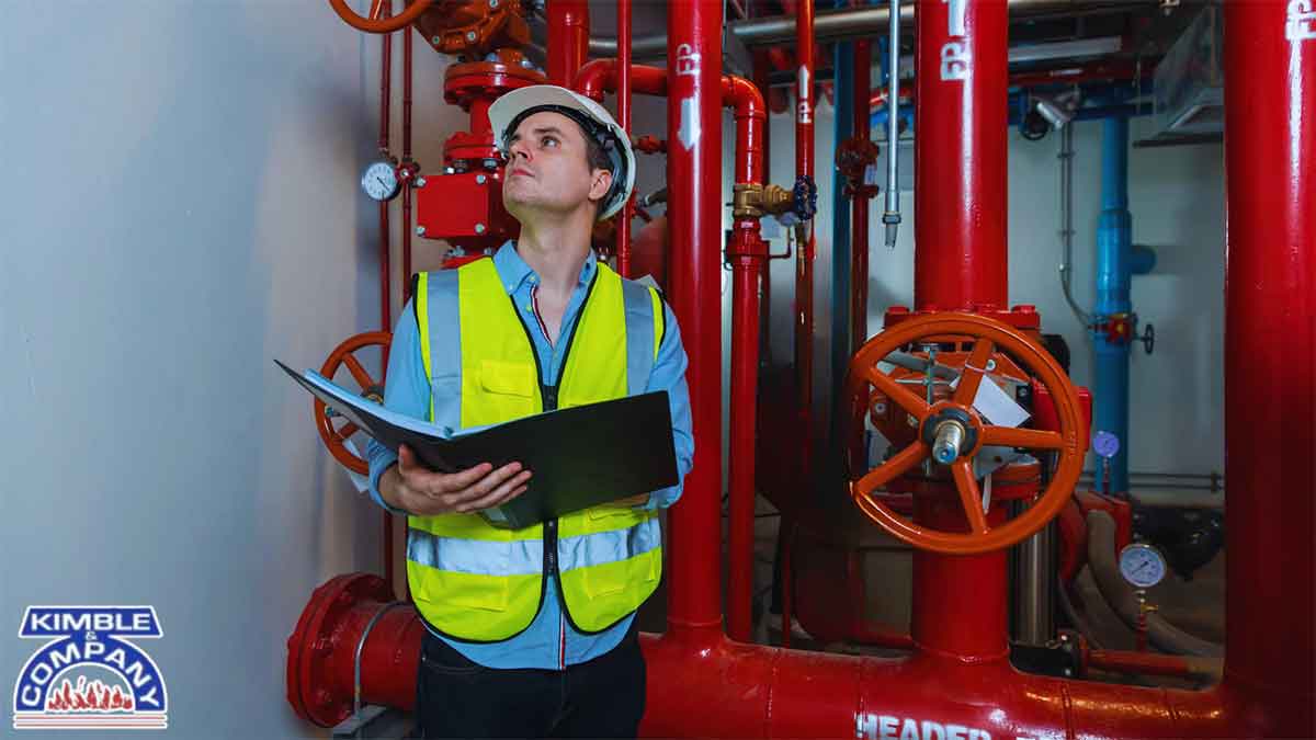 Fire safety technician reviewing fire sprinkler system during annual fire inspections made simple