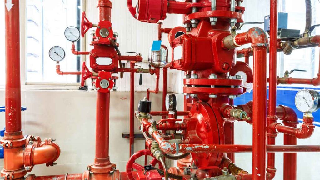 Red commercial fire sprinkler system with gauges and valves