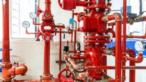 Red commercial fire sprinkler system with gauges and valves