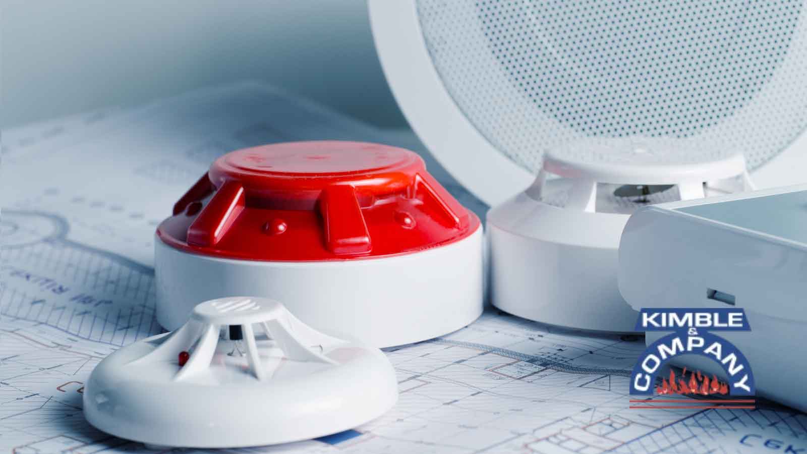 Fire alarm and smoke detector devices on blueprints.