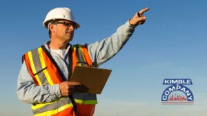 Inspector pointing while holding a clipboard.
