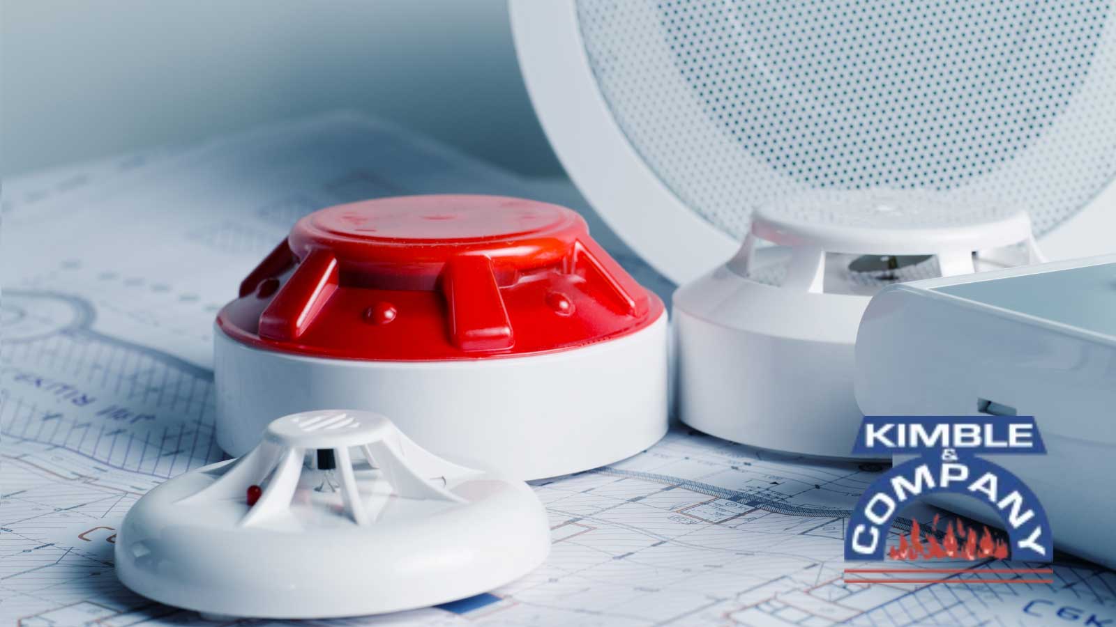 Fire alarm system components on a blueprint.