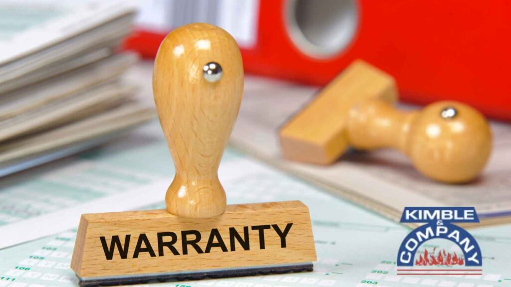 Wooden stamp with the word _WARRANTY_ on a desk